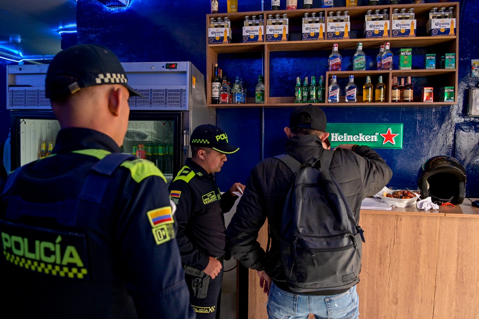 Hurto a comercio en Bogotá se reduce 65,5 % en lo corrido de 2026 Dos Policías junto a un hombre en un establecimiento comercial
