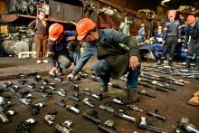 Hombres con armas próximas a destruir en el piso